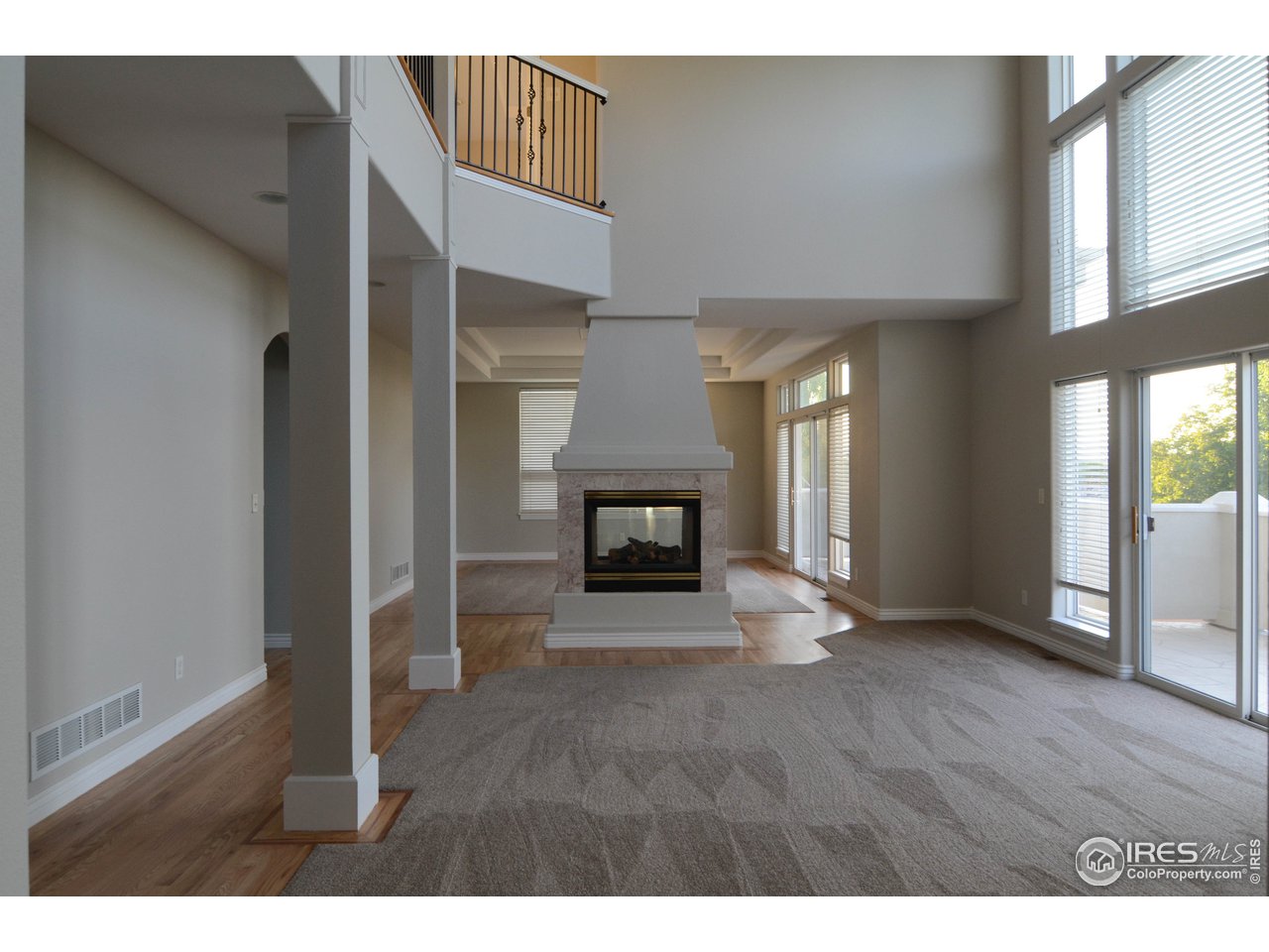 1797 Ridge W Drive Windsor, CO 80550 - Photo 3 of 33 a view of an empty room with a fireplace and a window