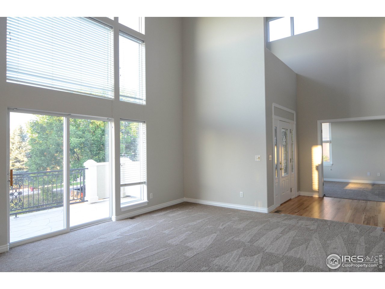 1797 Ridge W Drive Windsor, CO 80550 - Photo 4 of 33 a view of an empty room with wooden floor and a window