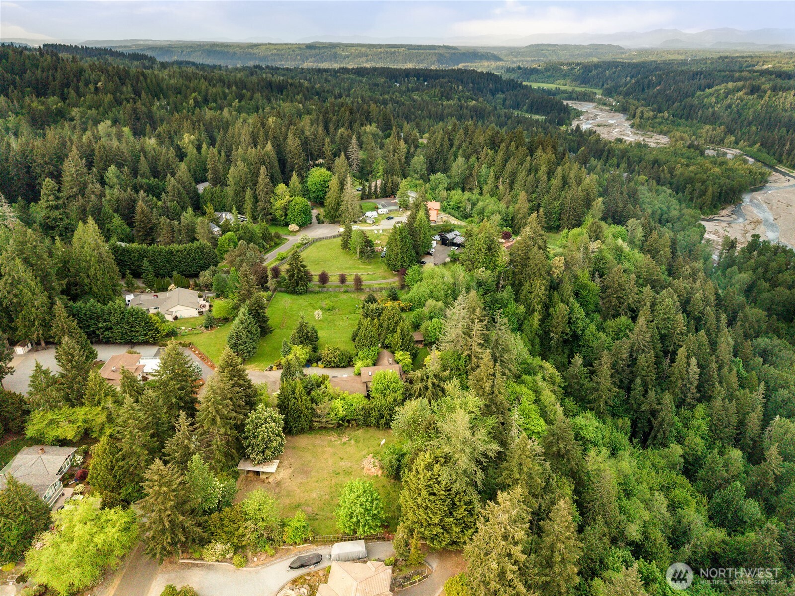 23519 Rim Road Graham, WA 98338 - Photo 16 of 23 a view of a green field with lots of bushes
