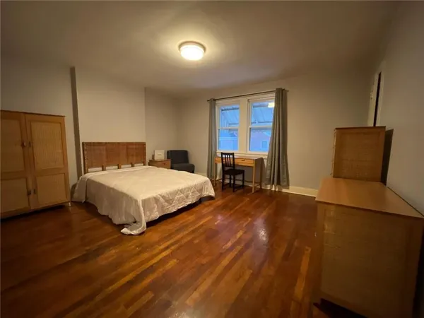 a bedroom with a bed chair and a window