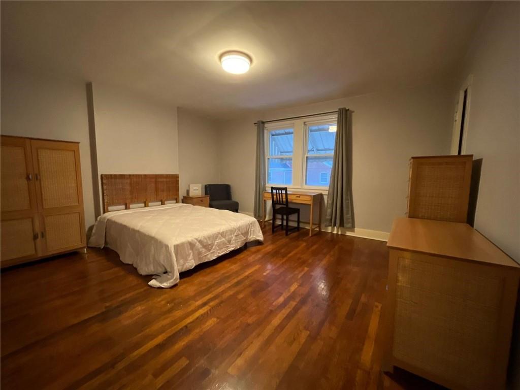 518 Belgreen Place, Unit 516 Pittsburgh, PA 15213 - Photo 11 of 17 a bedroom with a bed chair and a window