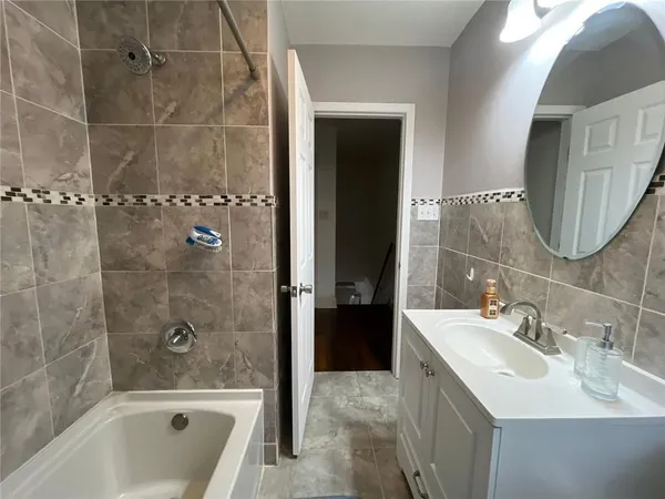 a bathroom with a bathtub and a sink