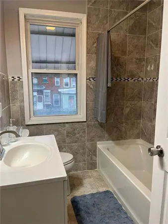 a bathroom with a sink a bathtub and a shower