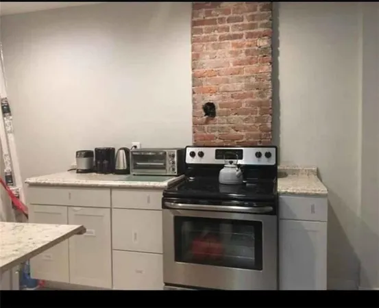 a stove top oven sitting inside of a kitchen