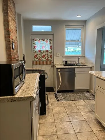 a kitchen with stainless steel appliances granite countertop a sink and a stove top oven