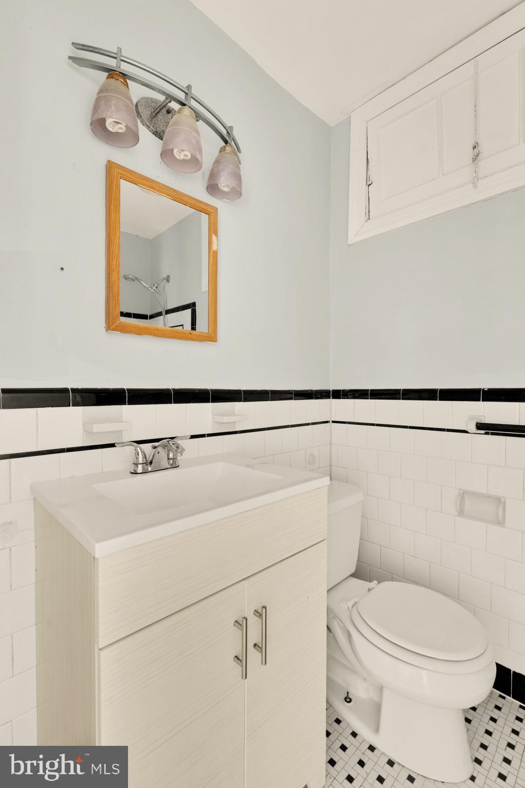 1227 18th Place Northeast Washington, DC 20002 - Photo 12 of 23 a bathroom with a toilet sink and mirror