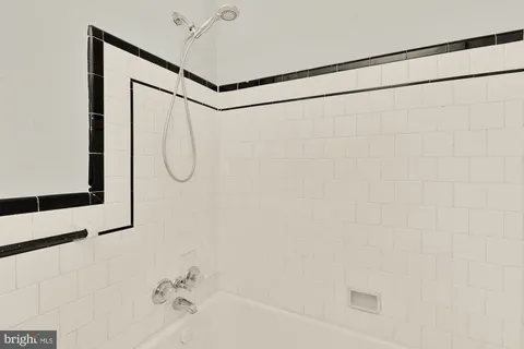 a bathroom with a shower and a mirror