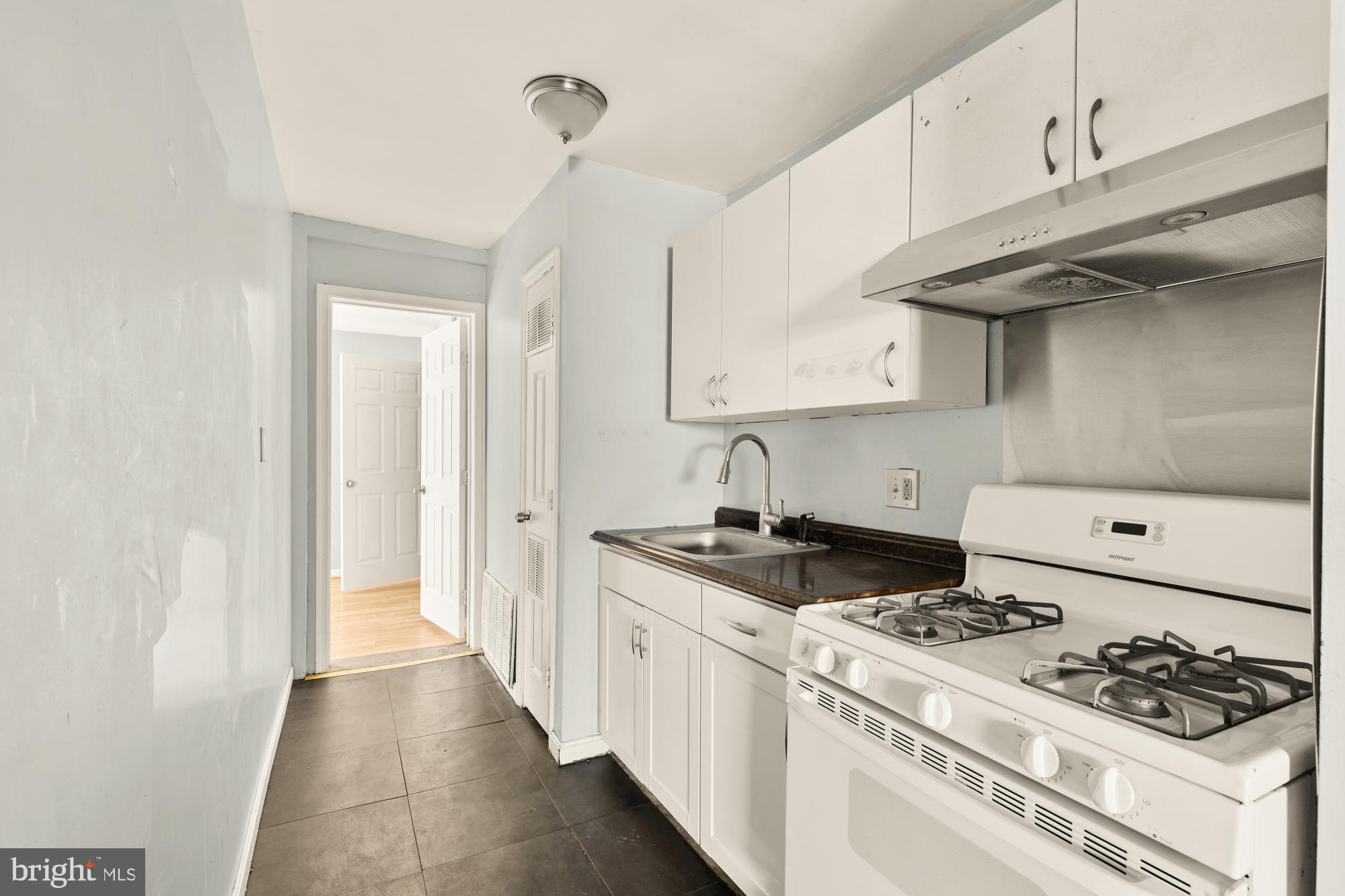 1227 18th Place Northeast Washington, DC 20002 - Photo 17 of 23 a kitchen with stainless steel appliances granite countertop a stove and a wooden cabinets