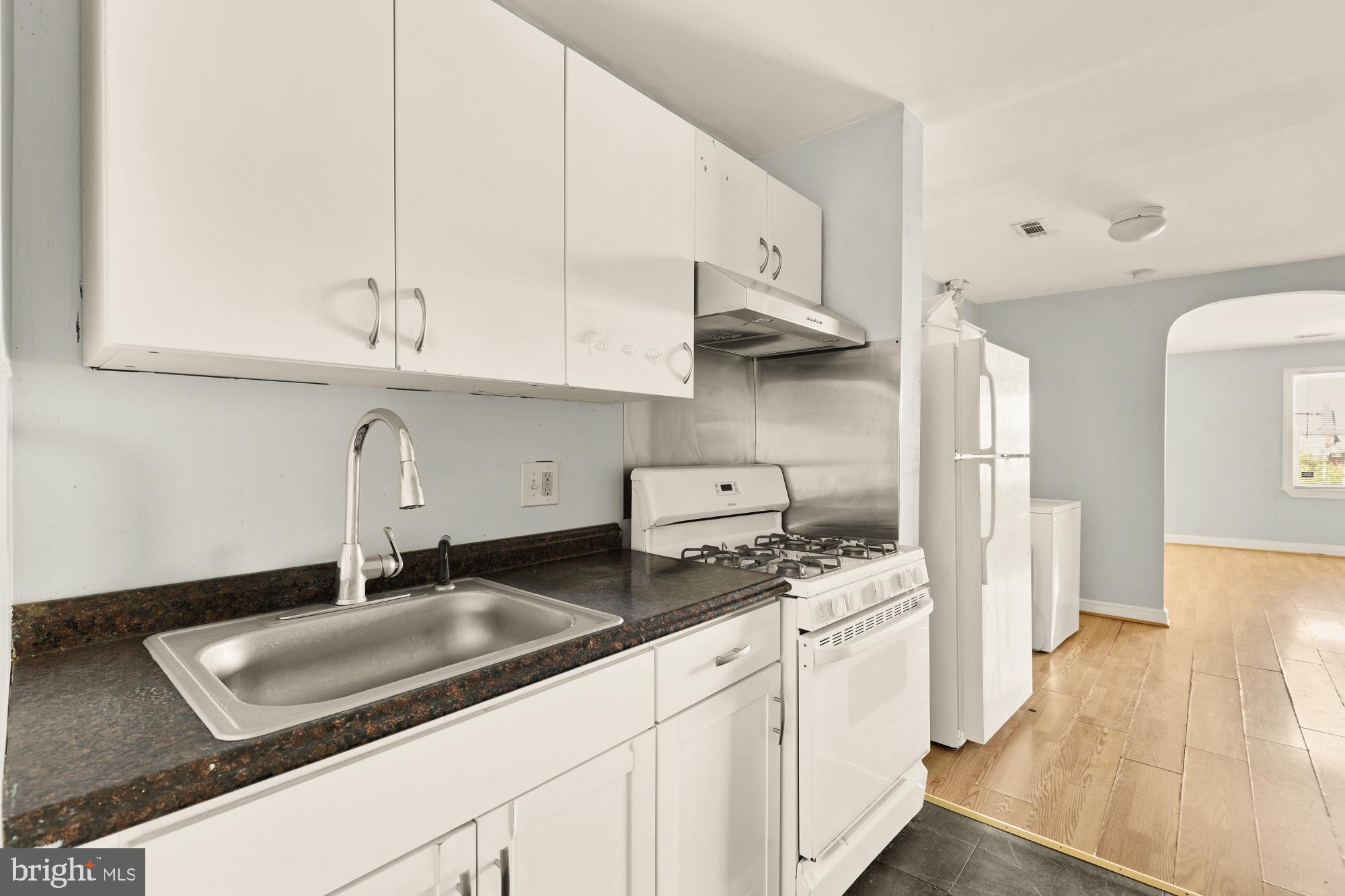 1227 18th Place Northeast Washington, DC 20002 - Photo 18 of 23 a kitchen with stainless steel appliances granite countertop a sink stove and cabinets