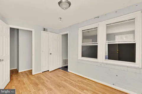 a view of an empty room with a fireplace and cabinet