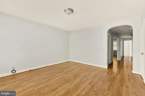 a view of a room with wooden floor and fence
