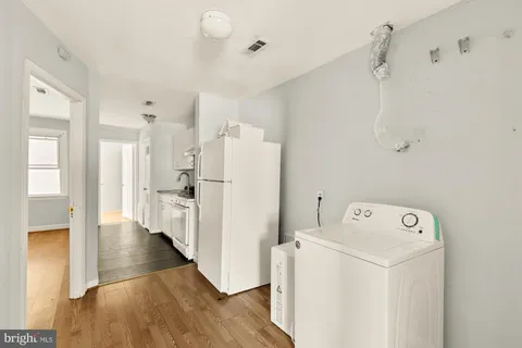 a view of a storage & utility room with wooden floor