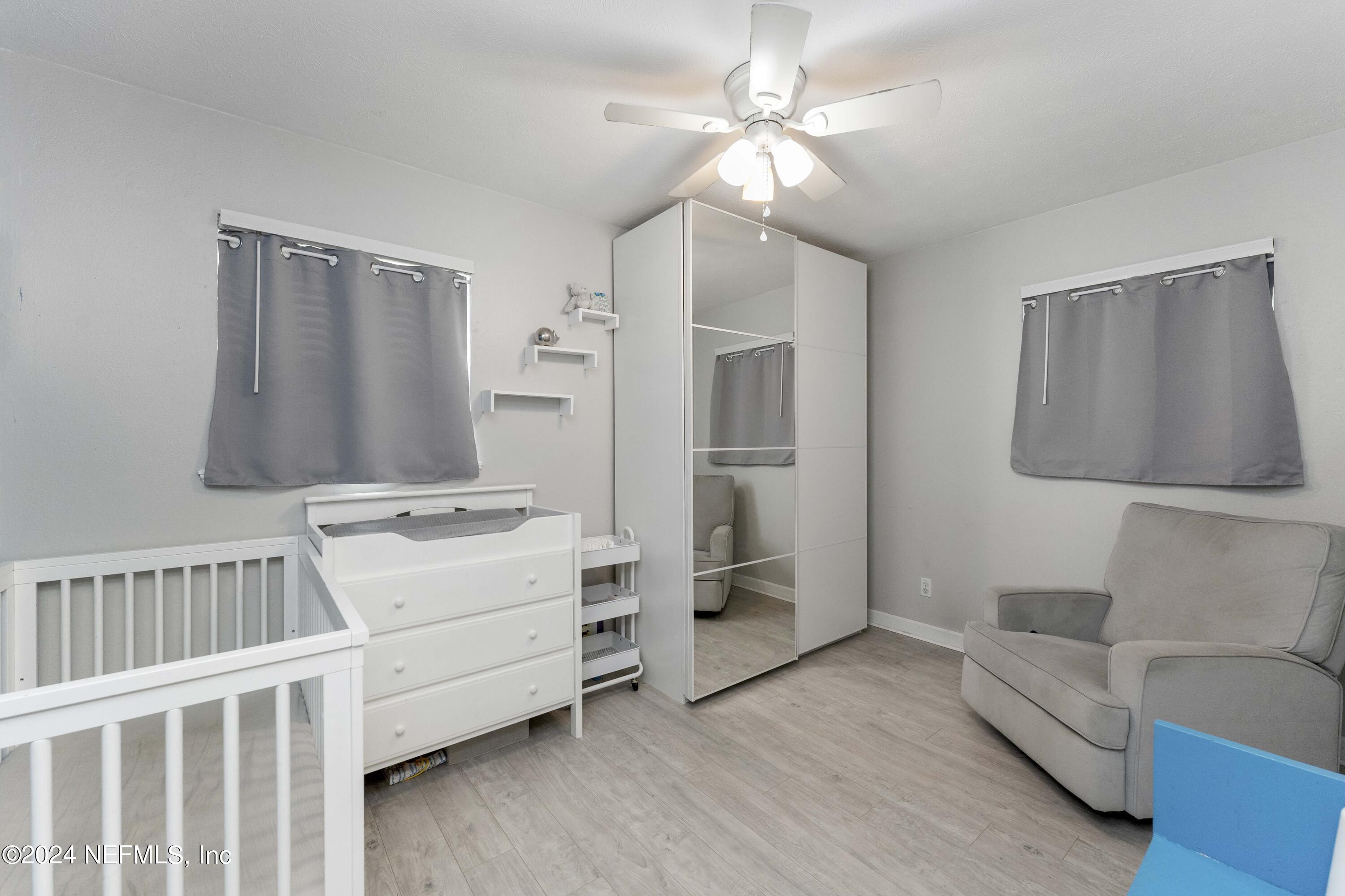 381 Sargo Road Atlantic Beach, FL 32233 - Photo 12 of 24 a living room with furniture and a baby crib