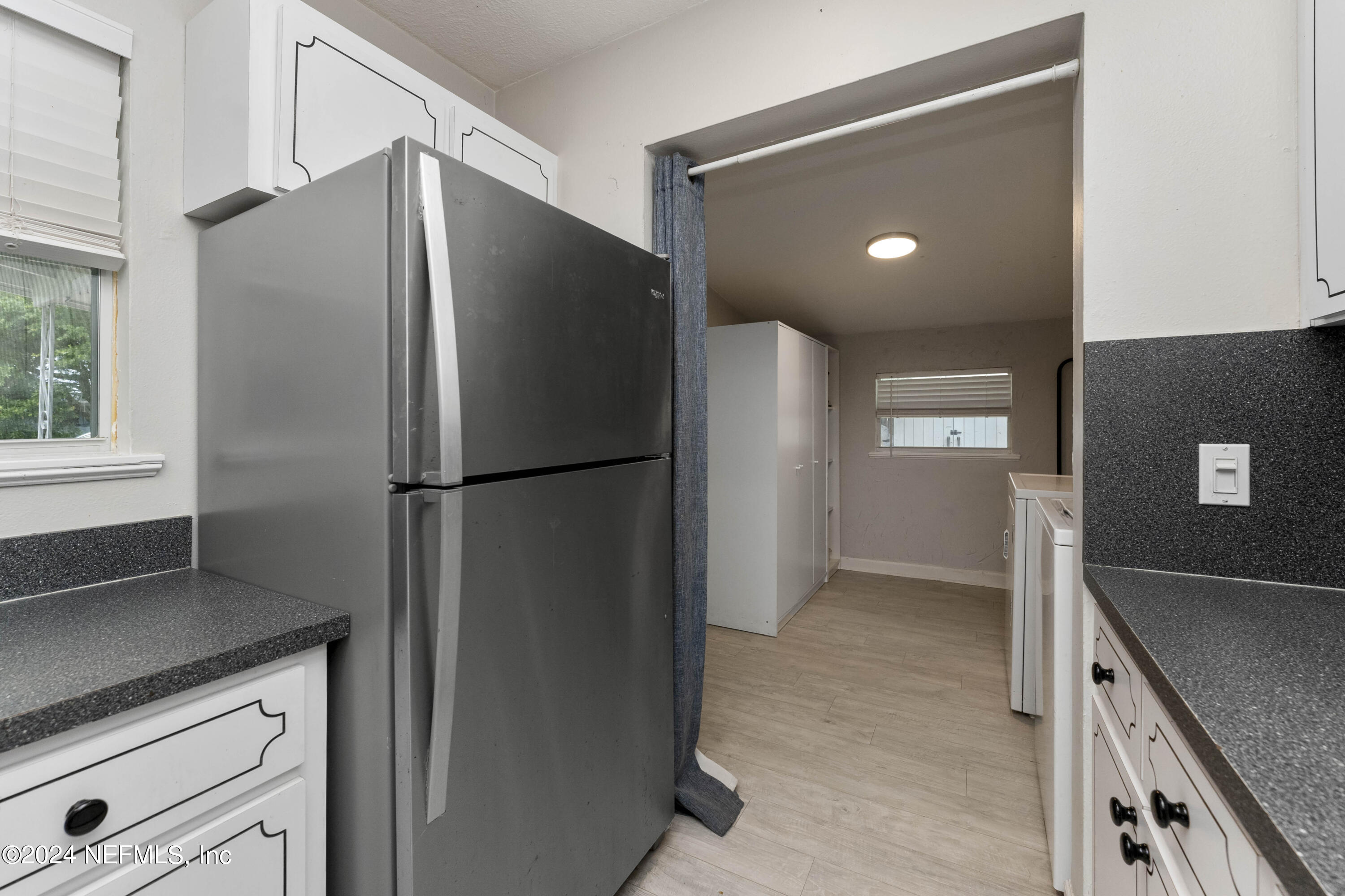 381 Sargo Road Atlantic Beach, FL 32233 - Photo 9 of 24 a kitchen with a refrigerator and countertop