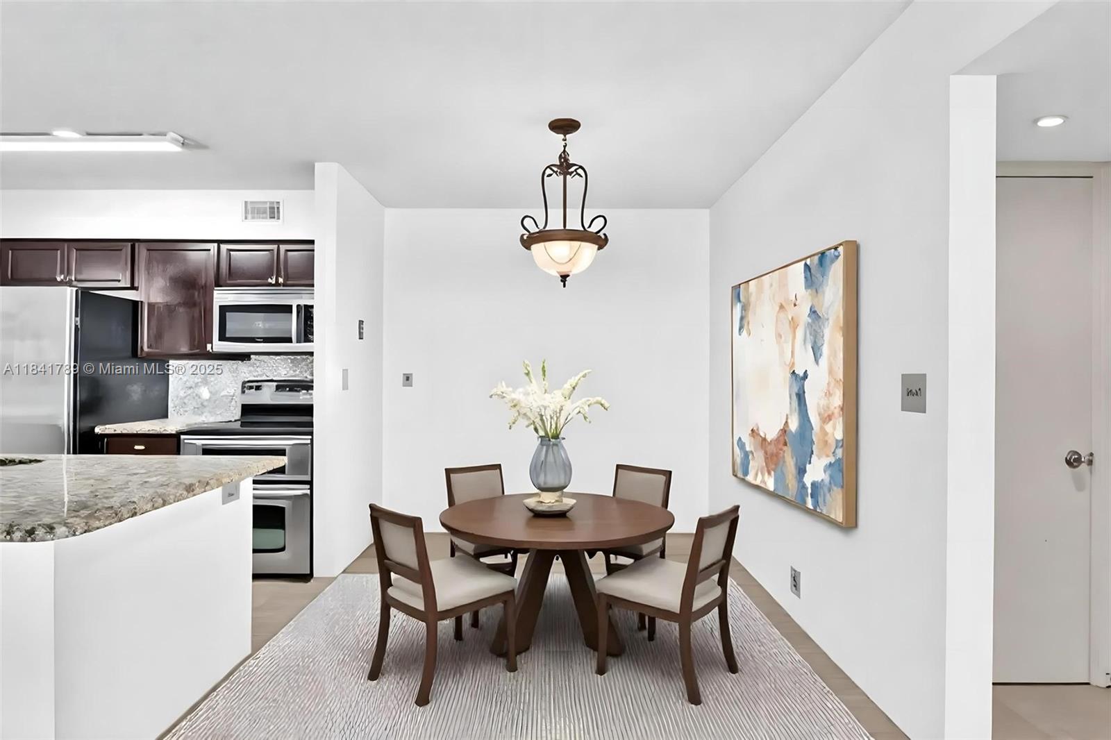 2796 South University Drive, Unit 2104 Davie, FL 33328 - Photo 3 of 41 a dining room with stainless steel appliances furniture a chandelier and a window