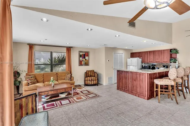 a living room with furniture a wooden floor and a window