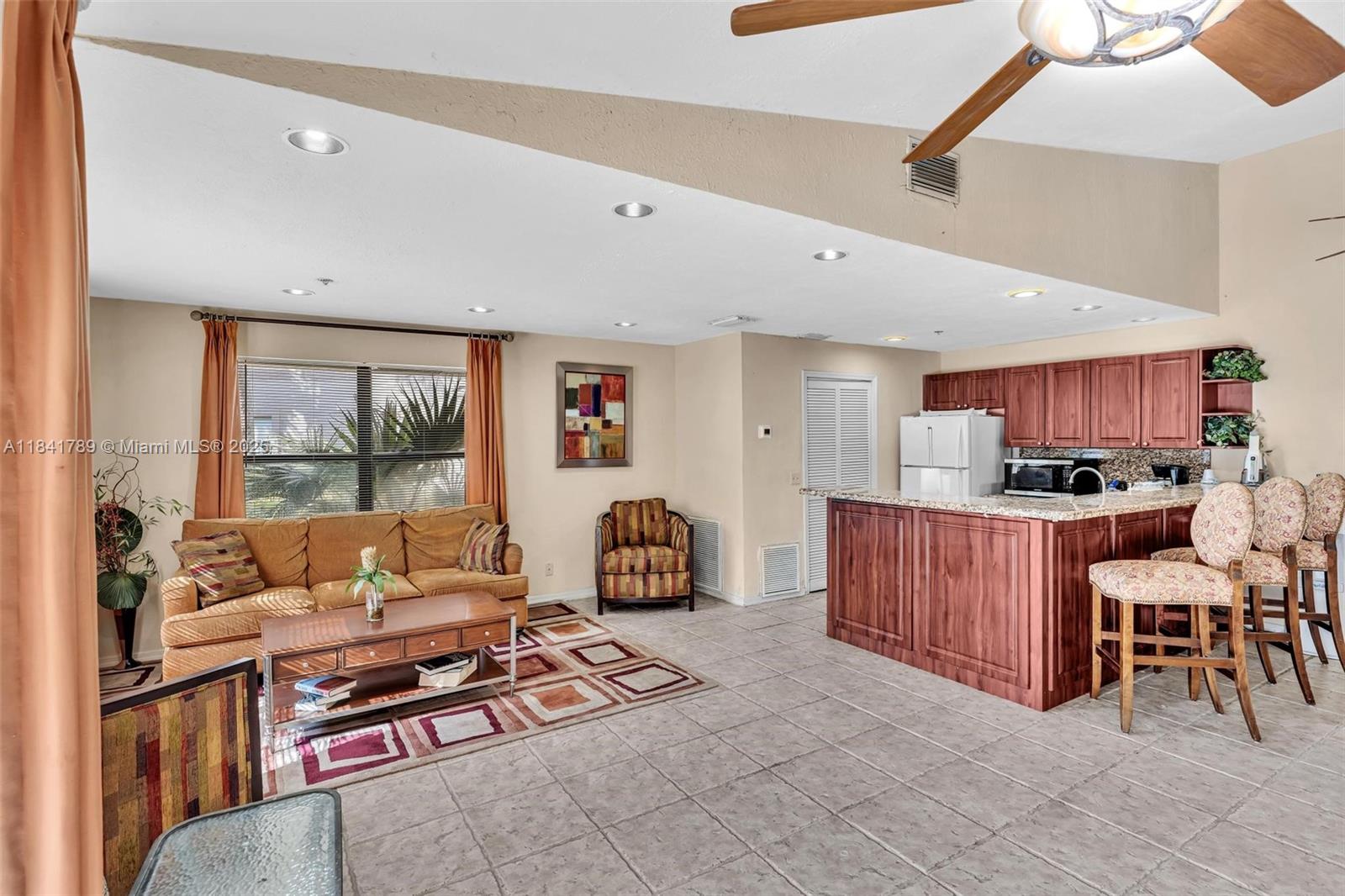 2796 South University Drive, Unit 2104 Davie, FL 33328 - Photo 36 of 41 a living room with furniture a wooden floor and a window