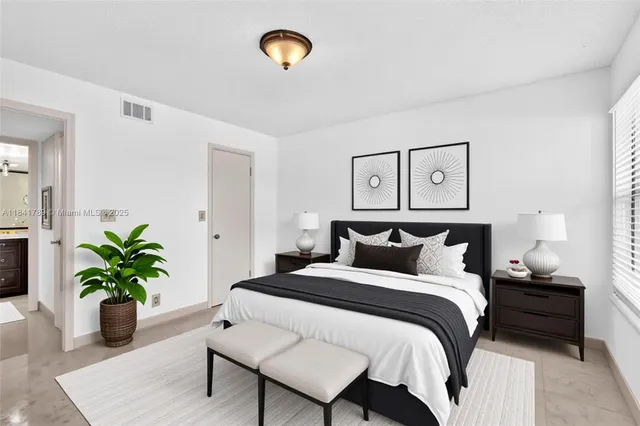 a bedroom with a bed and a potted plant