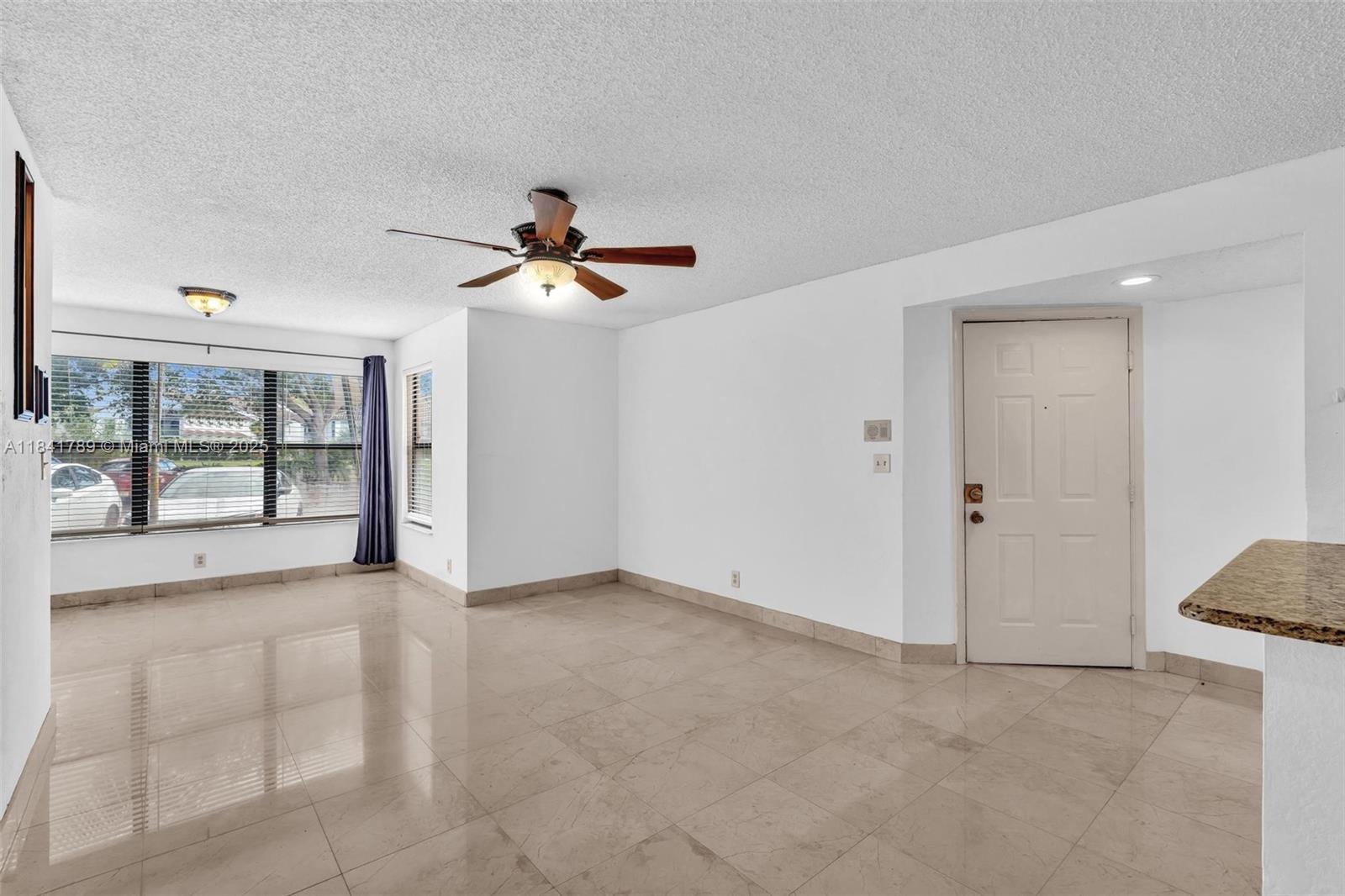 2796 South University Drive, Unit 2104 Davie, FL 33328 - Photo 5 of 41 a view of an empty room with a window