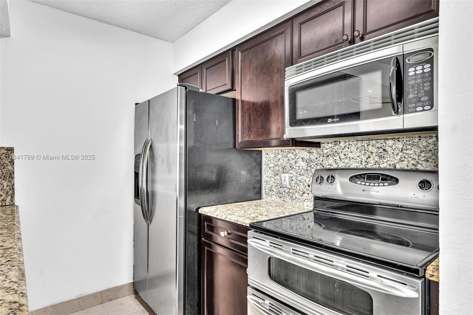 2796 South University Drive, Unit 2104 Davie, FL 33328 - Photo 10 of 41 a kitchen with a stove microwave and refrigerator