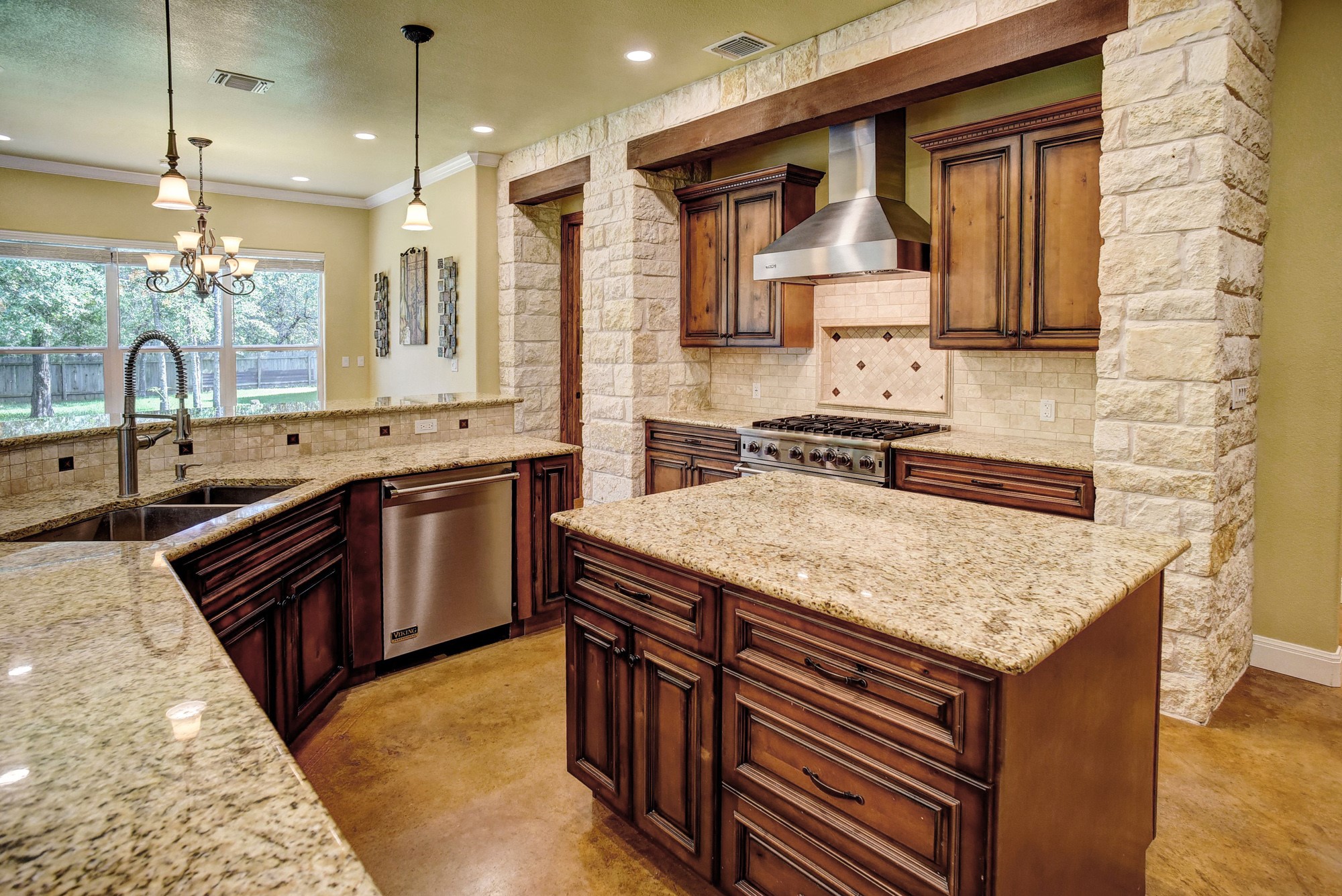 115 Pine Point Cove Elgin, TX 78621 - Photo 13 of 39 A well-appointed kitchen showcasing rich cabinetry, granite counters, and a spacious island.