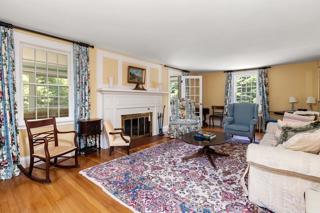 29 Sunset Road Weston, MA 02493 - Photo 13 of 29 a living room with furniture a rug wooden floor and a fireplace