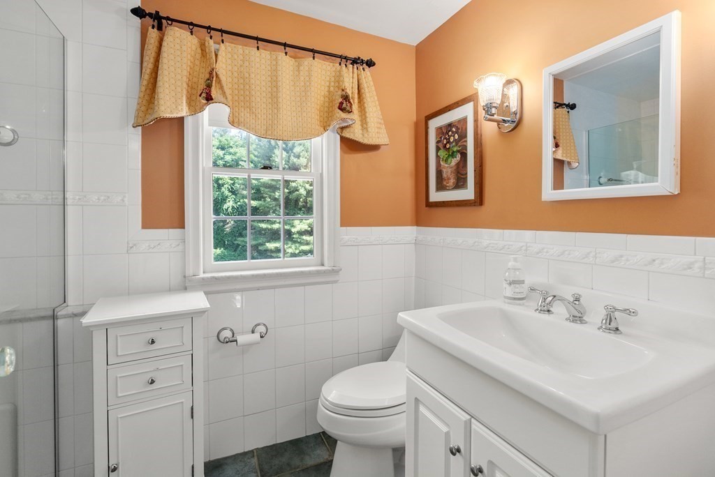 29 Sunset Road Weston, MA 02493 - Photo 18 of 29 a bathroom with a sink a toilet and a mirror