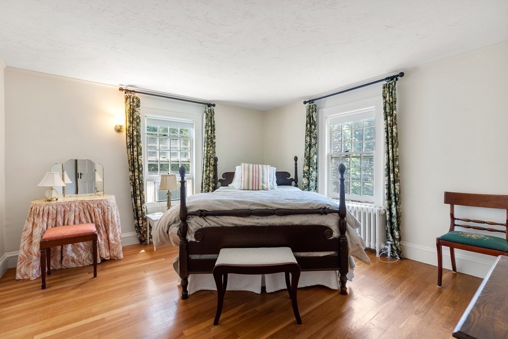 29 Sunset Road Weston, MA 02493 - Photo 21 of 29 a bedroom with a bed and a chair