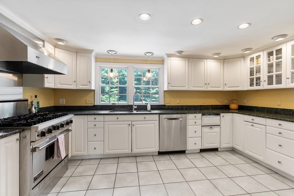 29 Sunset Road Weston, MA 02493 - Photo 6 of 29 a kitchen with granite countertop white cabinets a sink a window and stainless steel appliances