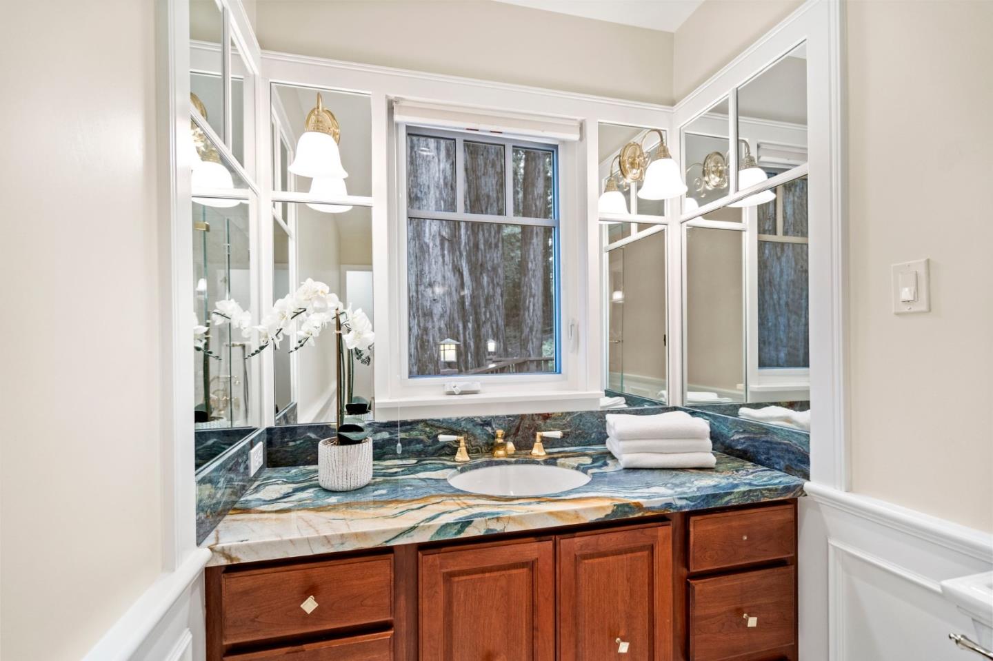 555 Summit Spring Road Woodside, CA 94062 - Photo 29 of 90 a bathroom with a granite countertop sink and a mirror