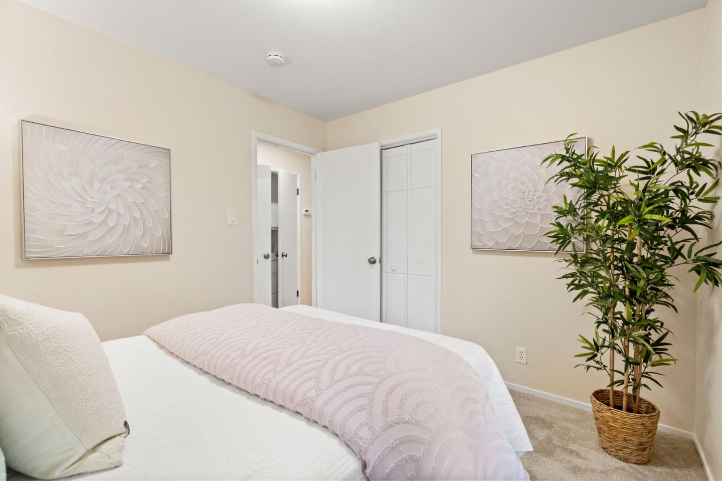 555 Summit Spring Road Woodside, CA 94062 - Photo 32 of 90 a bedroom with a large bed and a potted plant