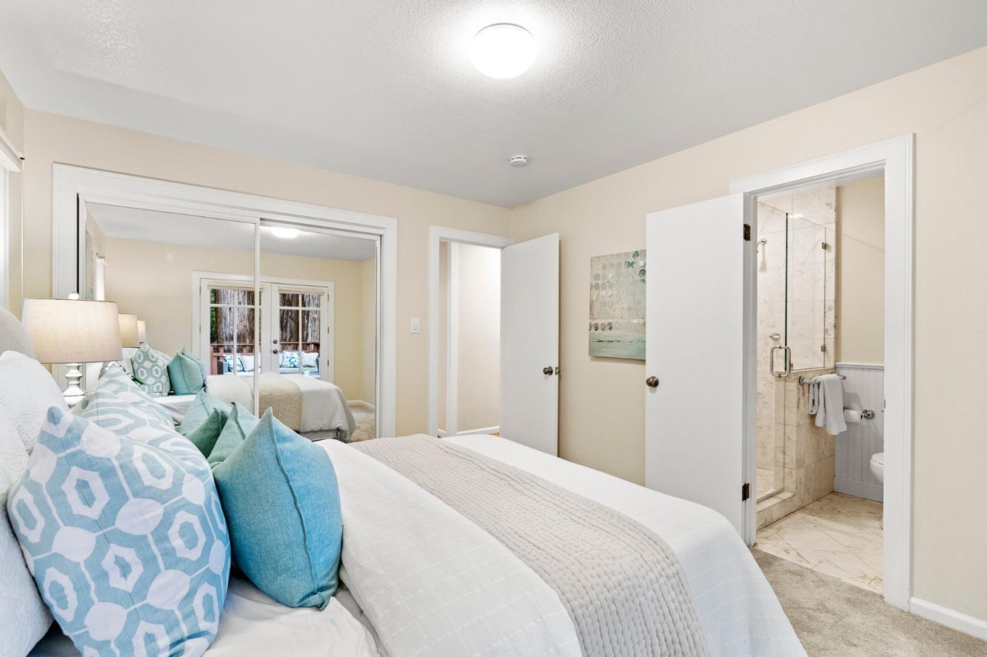 555 Summit Spring Road Woodside, CA 94062 - Photo 33 of 90 a bedroom with a large bed and a chandelier