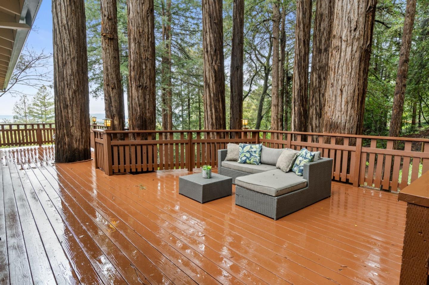 555 Summit Spring Road Woodside, CA 94062 - Photo 55 of 90 a view of a patio with couches and chairs with wooden floor and fence