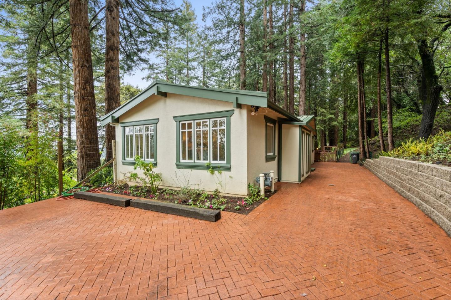 555 Summit Spring Road Woodside, CA 94062 - Photo 7 of 90 a front view of a house with a garden and trees