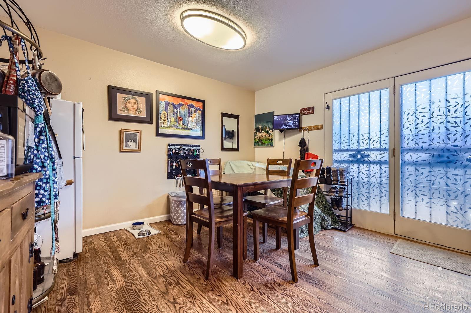 7920 East Phillips Circle Centennial, CO 80112 - Photo 3 of 13 a view of a dining room with furniture and wooden floor