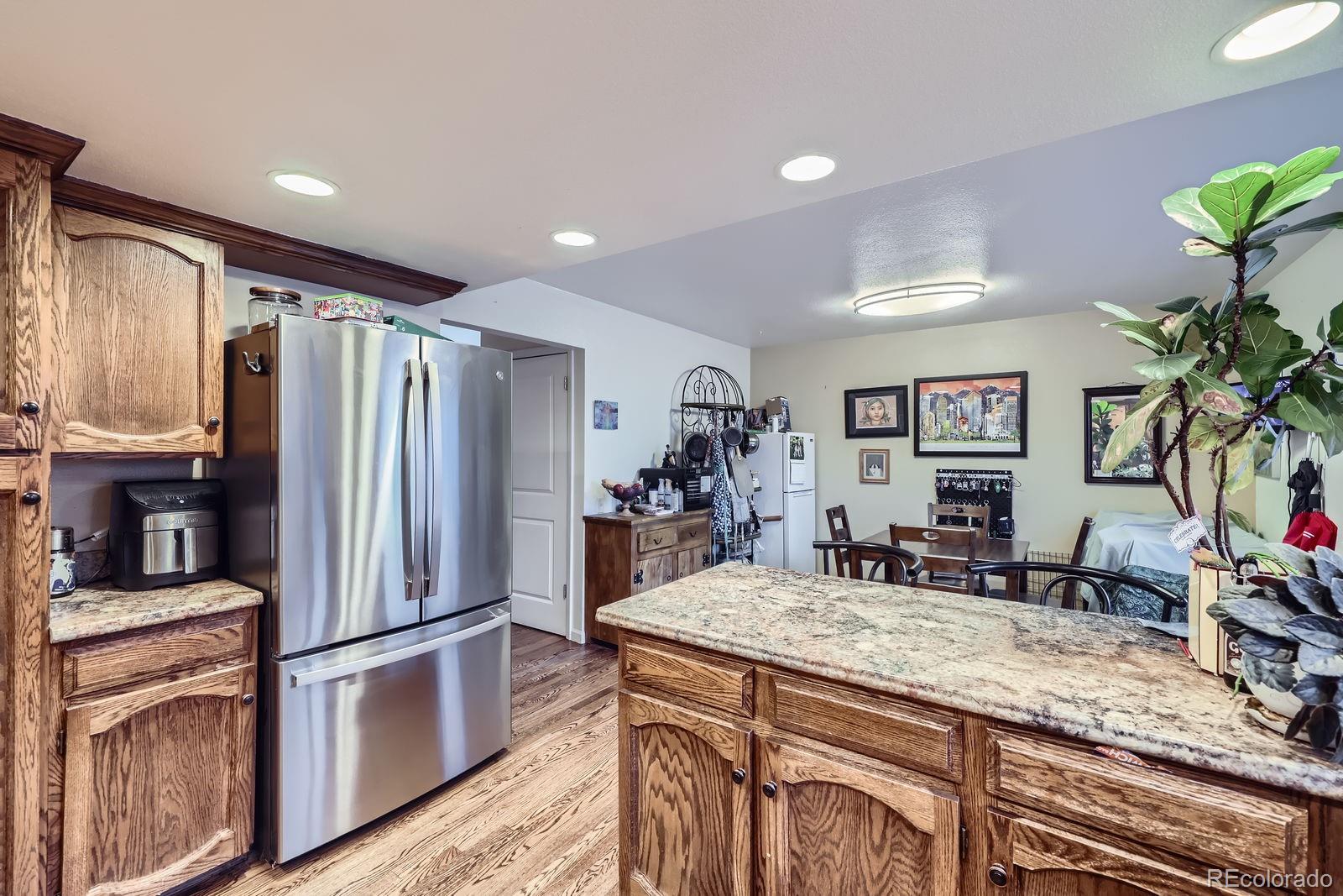 7920 East Phillips Circle Centennial, CO 80112 - Photo 5 of 13 a kitchen with stainless steel appliances granite countertop a refrigerator and a sink