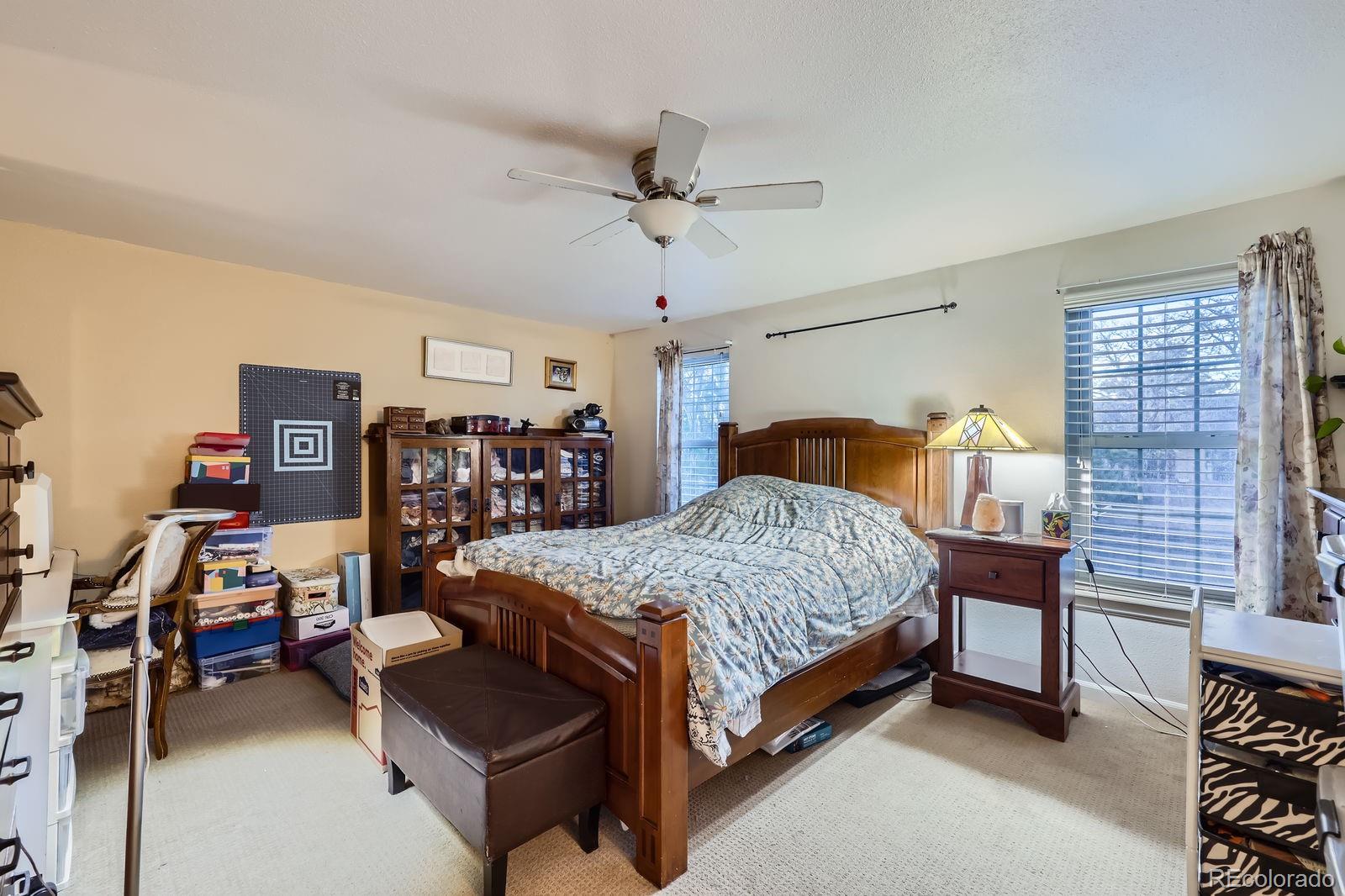 7920 East Phillips Circle Centennial, CO 80112 - Photo 7 of 13 a bedroom with a bed and a chandelier