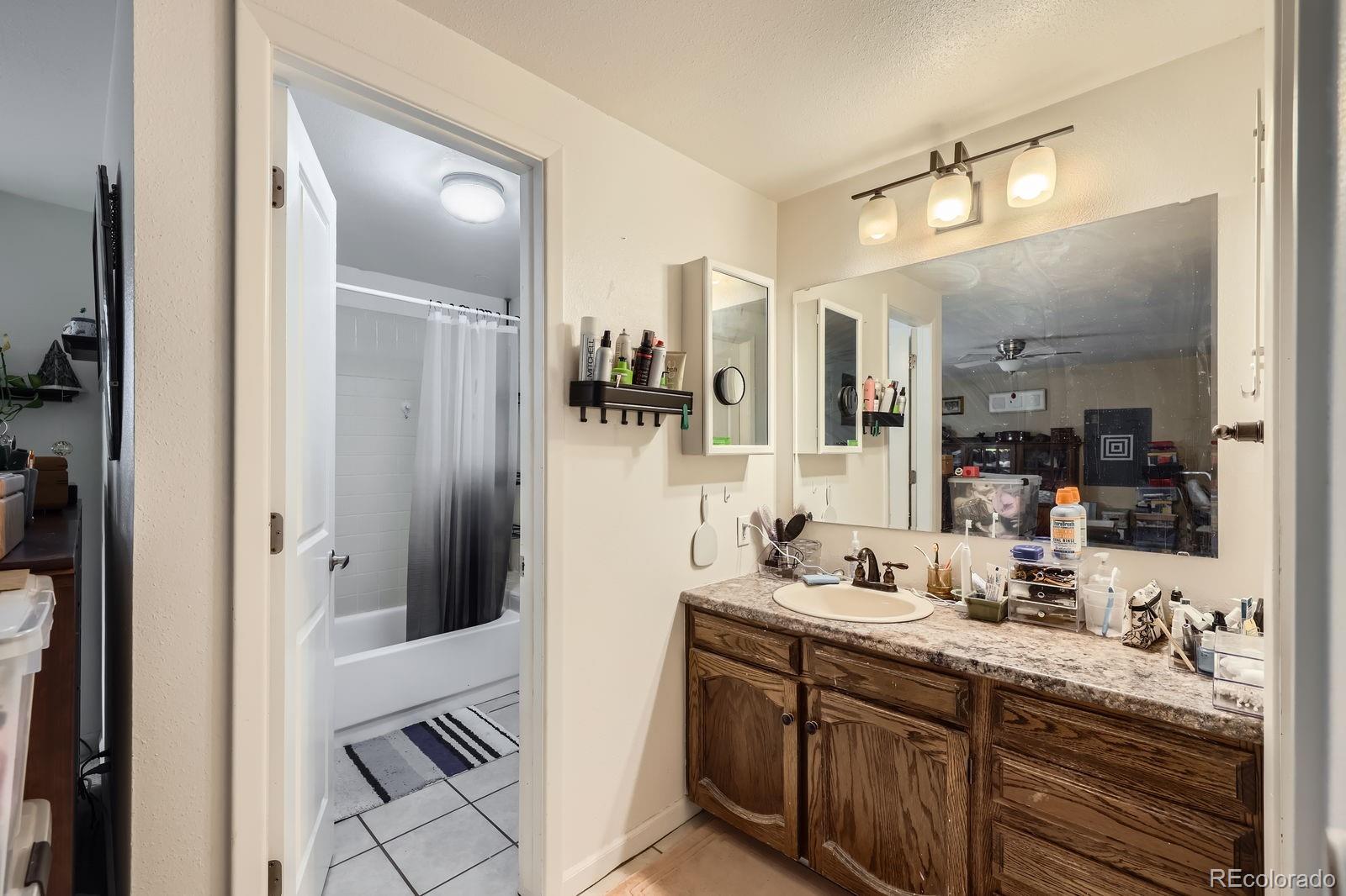 7920 East Phillips Circle Centennial, CO 80112 - Photo 8 of 13 a bathroom with a double vanity sink and mirror