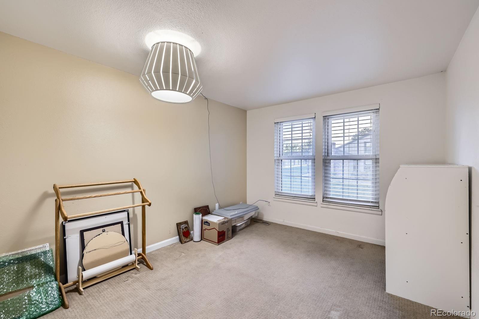 7920 East Phillips Circle Centennial, CO 80112 - Photo 9 of 13 a view of an empty room with a fireplace and a window