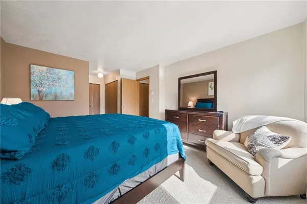 a bedroom with a bed and a dresser in it