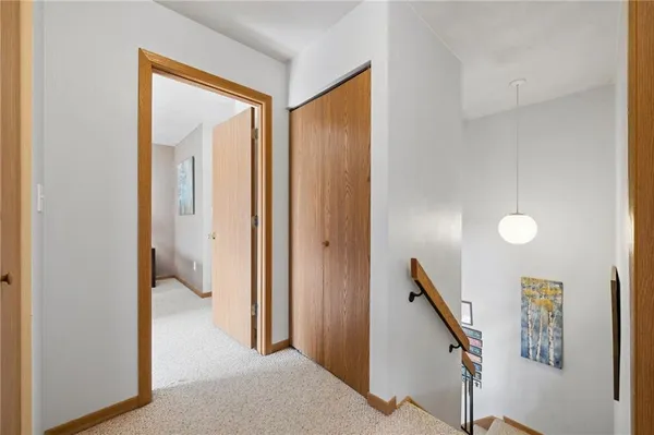 a view of a hallway with windows and stairs