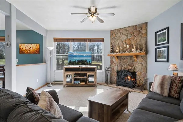 a living room with furniture a fireplace and a flat screen tv