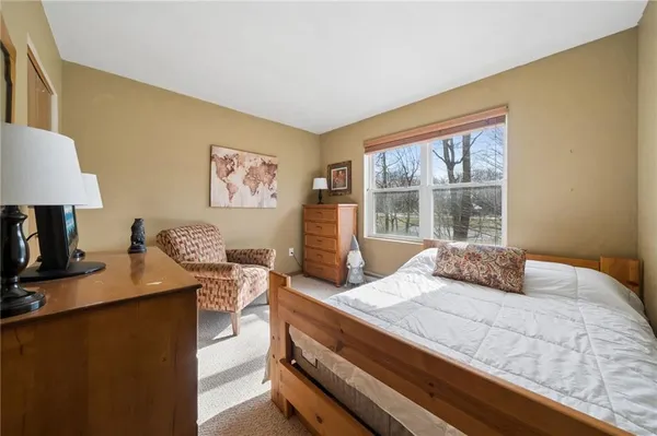 a bedroom with a bed and a desk