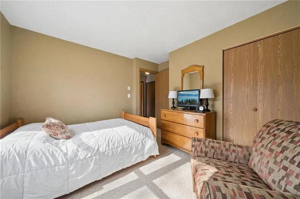 a bedroom with a bed and a sink