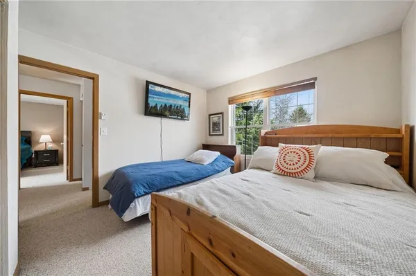 a bedroom with two beds and a window