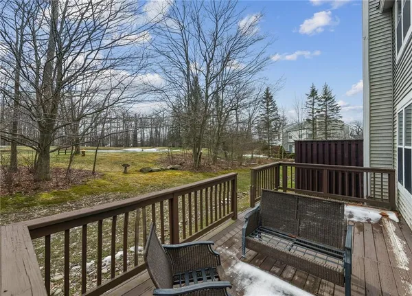 a balcony with wooden floor and fence