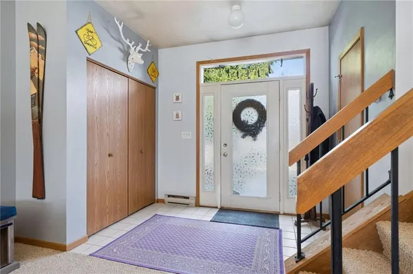 a view of an entryway with wooden floor and a hallway