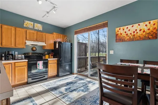 a kitchen with stainless steel appliances kitchen island granite countertop a refrigerator cabinets and wooden floor