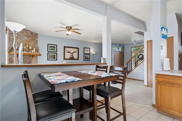 a view of a dining room with furniture and a potted plant