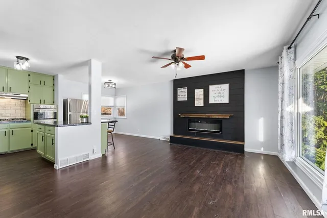a view of kitchen and hall with wooden floor